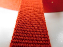Red aramid fiber webbing for fire safety clothing